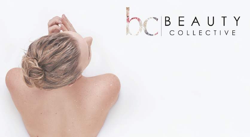 A woman with her hair in a bun is seen from above, relaxing in a white bath. The words bc BEAUTY COLLECTIVE are displayed in the top right corner.